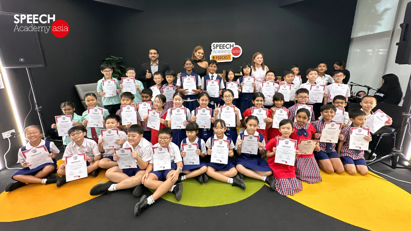 Students at Speech Academy Asia Singapore proudly holding their public speaking certifications after a leadership course.