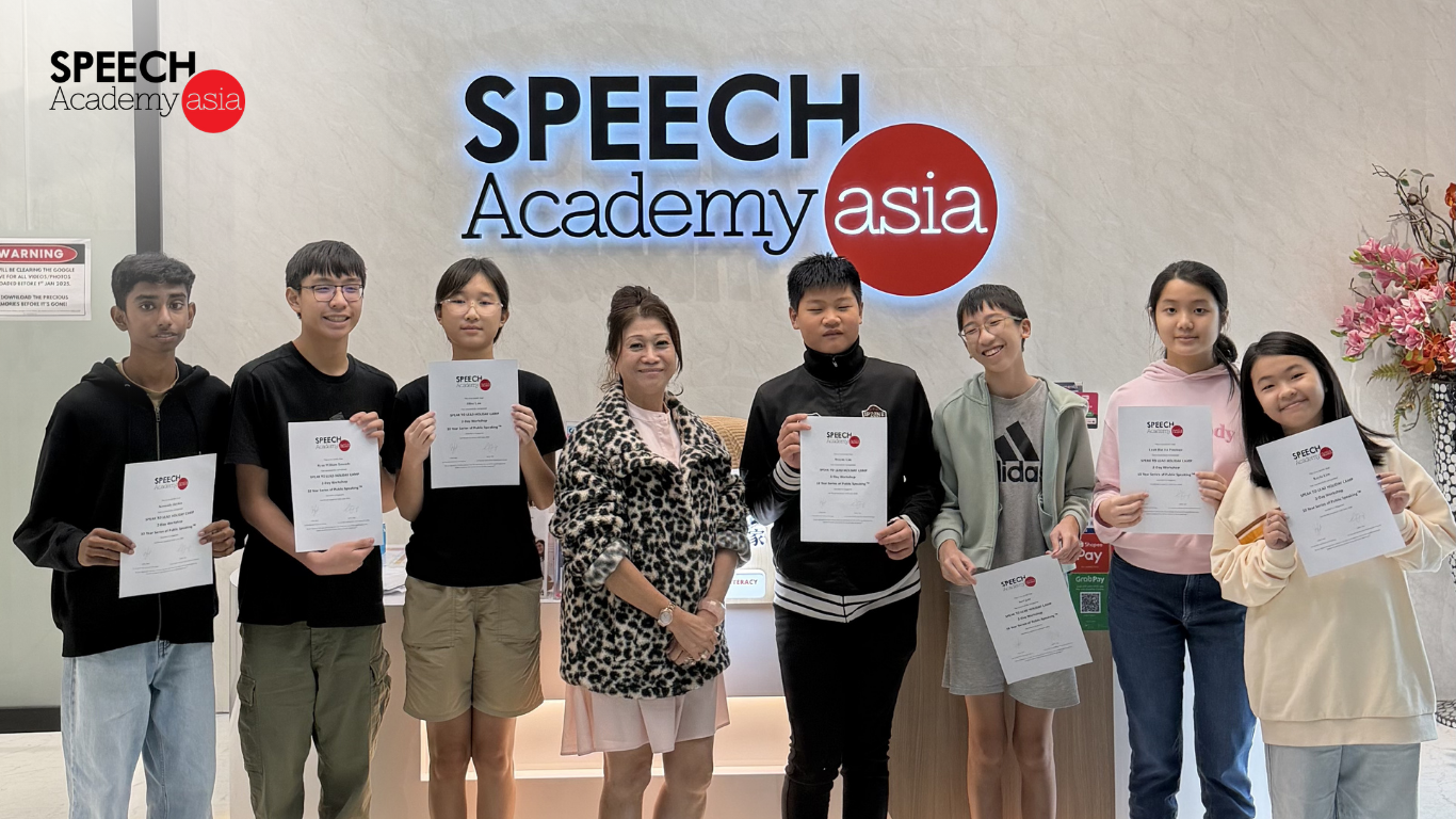 Students proudly holding their certificates after completing a public speaking course in Singapore