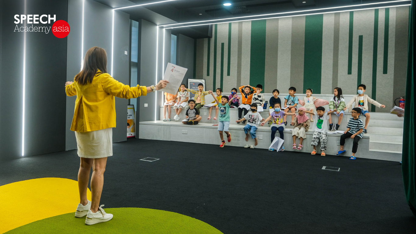 Trainer teaching an enthusiastic group of students during a public speaking class