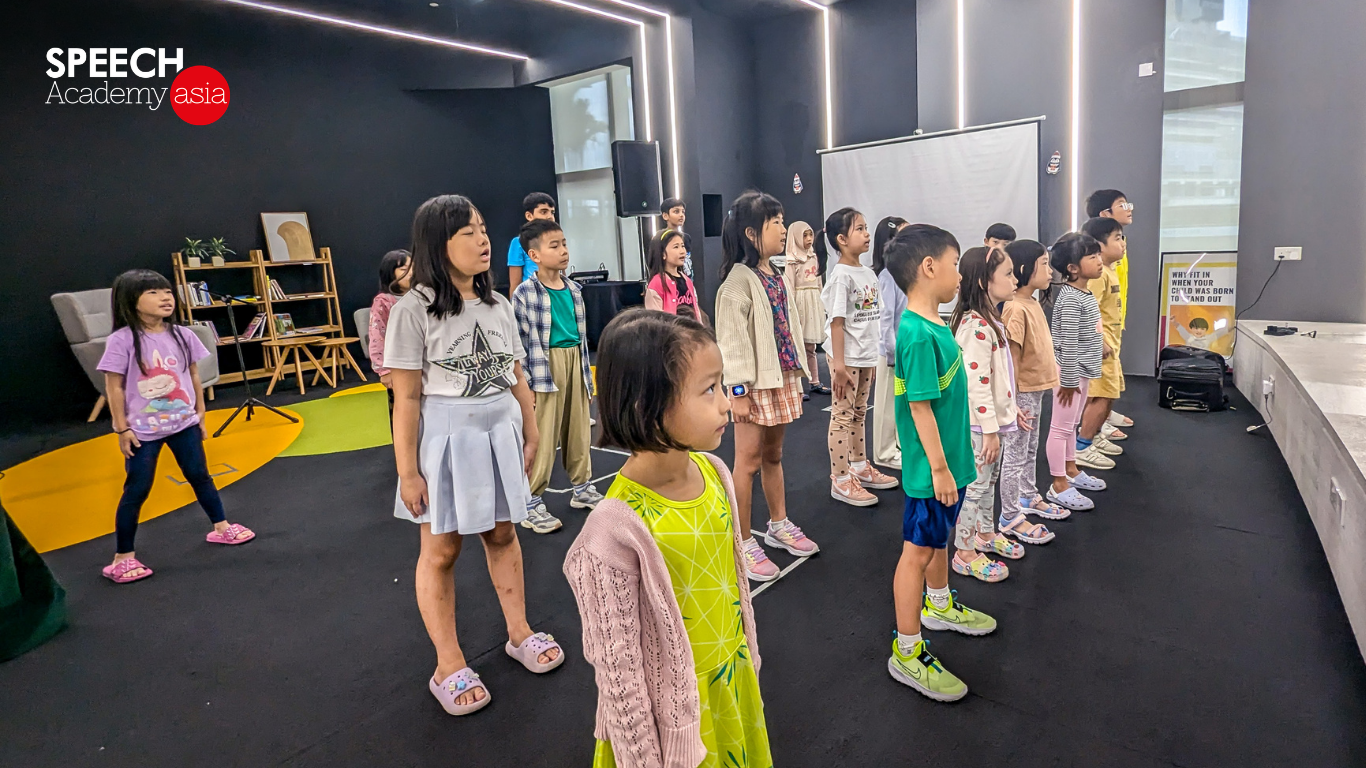 Students practising public speaking together in a classroom